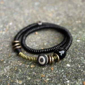 Tibetan Dzi bead double wrap bracelet with ebony wood beads and black onyx - top view flat lay