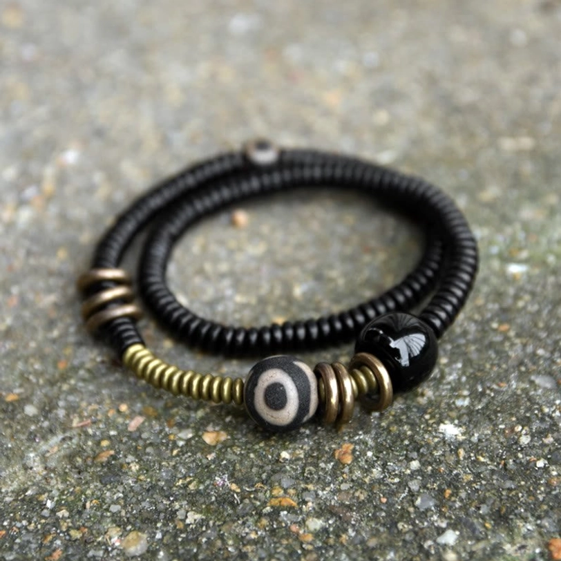Tibetan Dzi bead double wrap bracelet with ebony wood beads and black onyx - top view flat lay