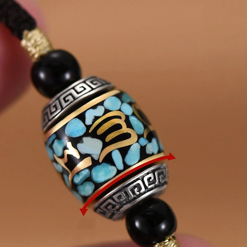 Rotatable Dzi bead pendant side macro detail showing intricate turquoise chips, gold script characters and silver geometric relief patterns