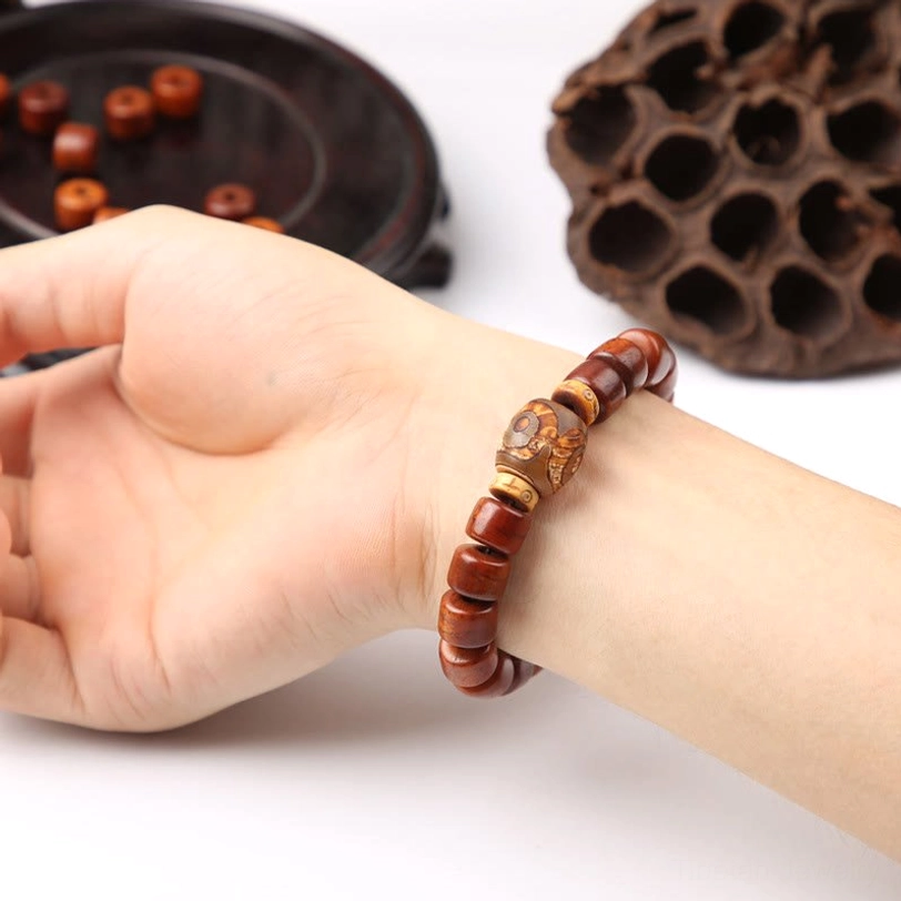 Wearable Tibetan three-eyed dzi bead bracelet with bone beads on wrist close-up