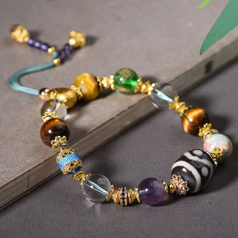 Overhead view of Tibetan gemstone bracelet with clear crystal and Dzi focal bead