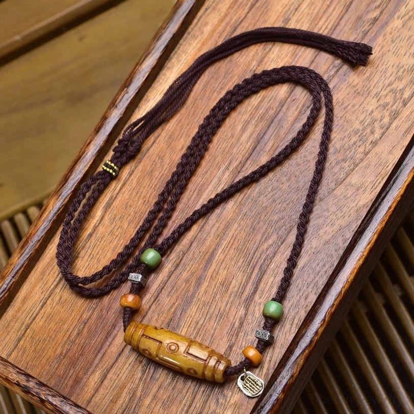 Authentic Tibetan Nine-Eye Dzi necklace with copper and bone beads featuring Chinese character silver charm