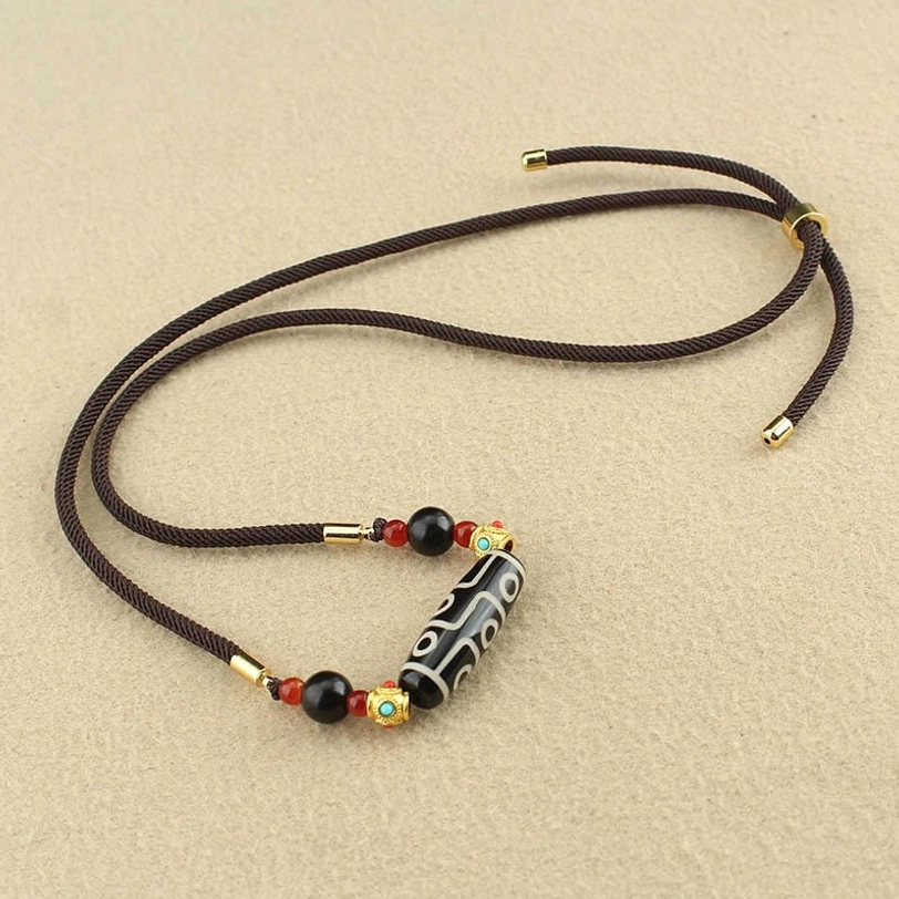 Dzi bead necklace with sliding metal clasp compact beaded design on light beige background