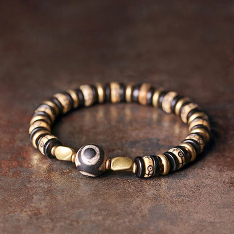 Ebony wood bone bead bracelet symmetric flat lay with metal spacers