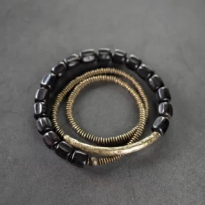 Multilayered Tibetan ebony wood and copper healing bracelet, top-down view showing coiled bead chain design on dark background