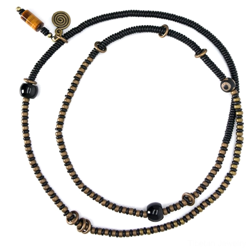 Tibetan ebony wood bracelet with Dzi beads and copper metal accents, artisanal handmade craftsmanship detail