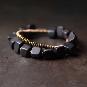 Tibetan ebony wood and copper double wrap bracelet displayed from top-down angle, showing two-layer beaded design with black wood beads and bronze metal coils on dark rustic surface