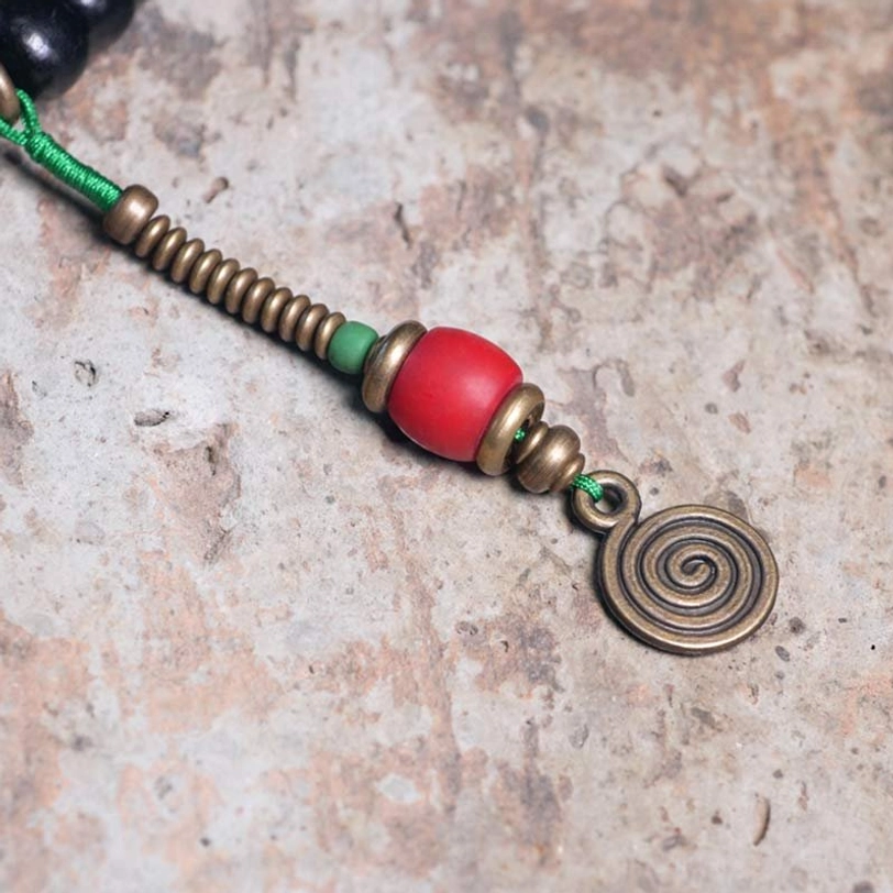 Tibetan ebony wood mala beads texture and quality close-up showing natural grain and spiritual grounding properties