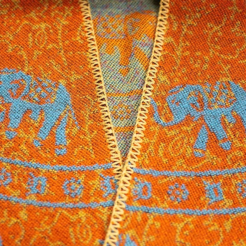 Burgundy and navy Tibetan elephant poncho with jacquard geometric patterns, layered wrap style