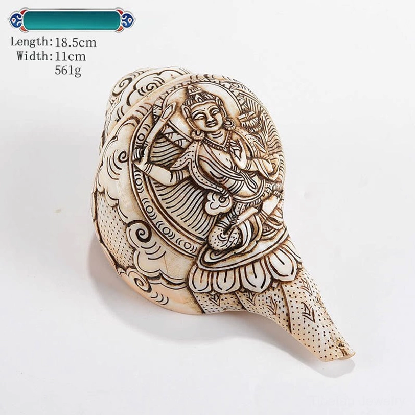 Natural Tibetan shankha conch shell with master-crafted Buddha engraving displayed on wooden base
