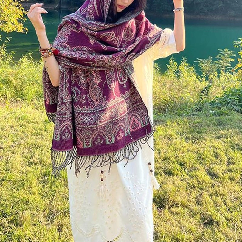 Ethnic Tibetan jacquard shawl with intricate patterns, worn over both shoulders at sunny grassland
