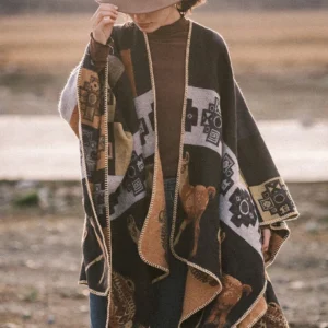 Brown ethnic Tibetan shawl poncho with geometric patterns paired with turtleneck and fedora casual styling