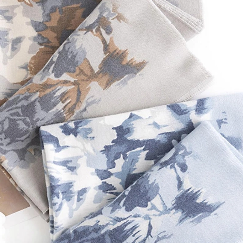 Tibetan ethnic scarf wrap showcasing detailed floral print pattern with rich color palette and soft draped fabric presentation