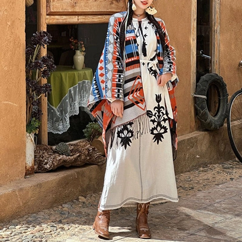 Ethnic geometric tassel shawl styled with embroidered white dress, vintage street shop exterior, side tassel trim detail