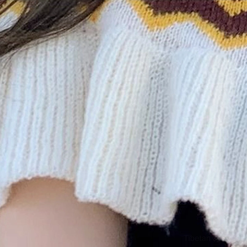 Tibetan ethnic shawl wrap featuring hand-crafted aesthetic with geometric stripes, tassels and authentic cultural design elements