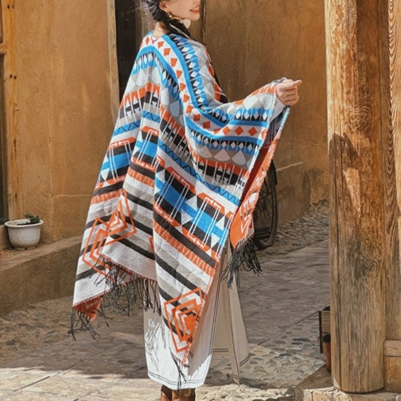 Ethnic geometric tassel shawl rear view, vintage street background, brown-gray tribal patterns with hand-finished fringe