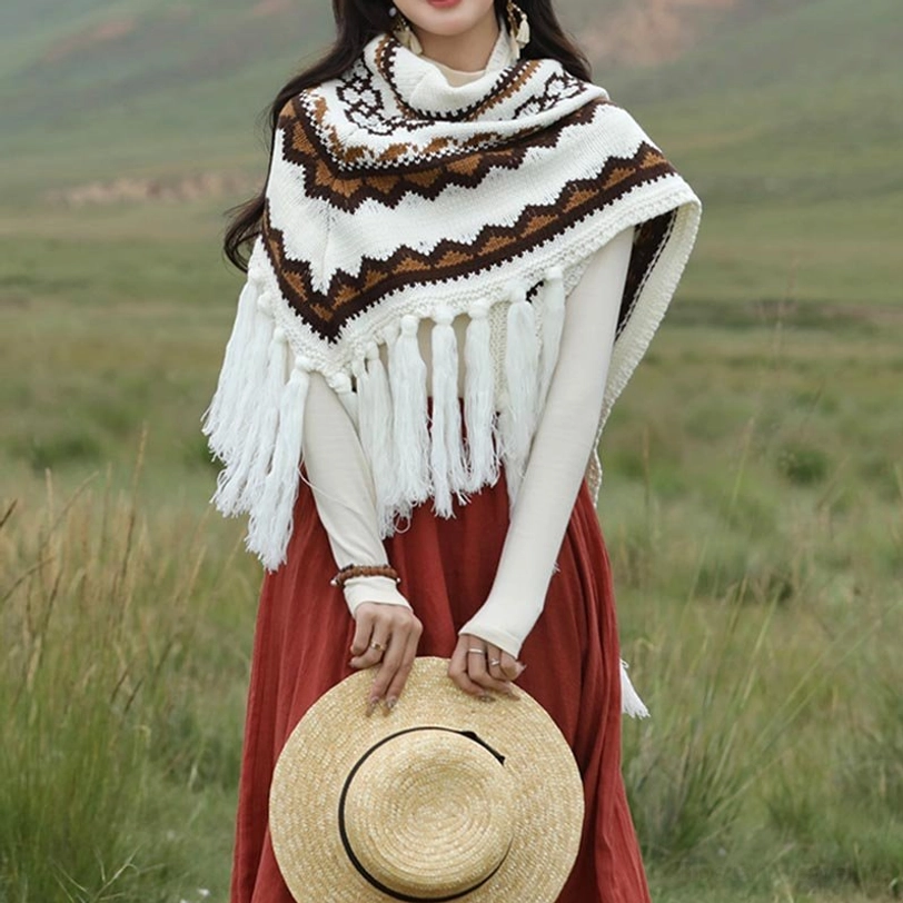 Woman seated wearing fringed ethnic Tibetan shawl with zigzag knit pattern and long tassel trim
