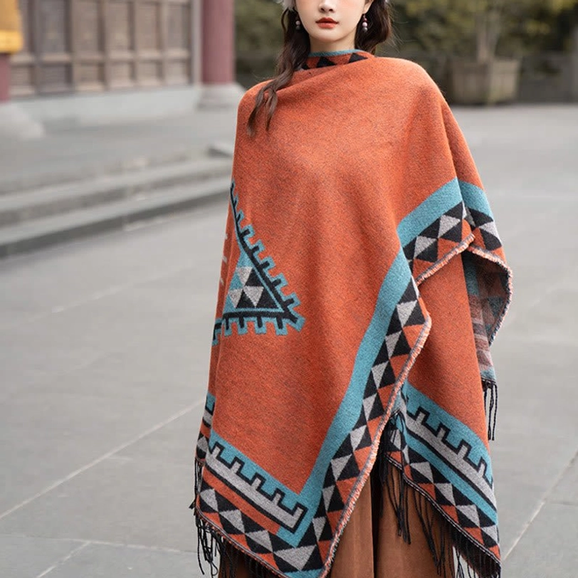 Front medium view of ethnic tassel shawl with solid upper section and geometric lower patterns, displayed on stone plaza background