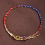 Handcrafted five-color Tibetan protection bracelet with multicolor braided rope and adjustable knot clasp, top-down view