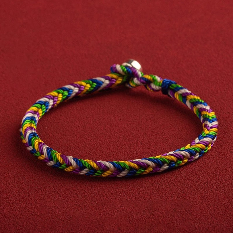 Handwoven five-element bracelet side-overhead view showing twisted braid design and metal buckle