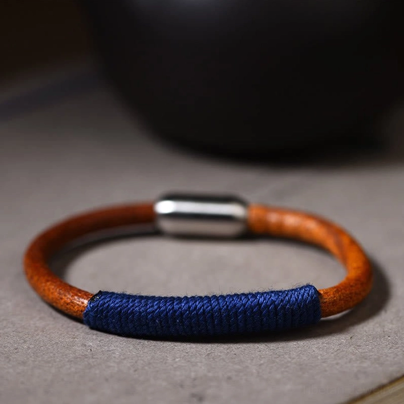 Tibetan five elements leather bracelet in blue water color worn on wrist - lifestyle arm shot