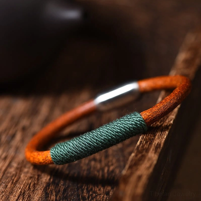 Handmade Tibetan five elements leather bracelet with green braided wrap and silver magnetic buckle - side close-up view
