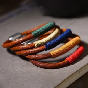 Collection of Tibetan five elements bracelets in multiple colors - red fire, blue water, green wood, beige metal, yellow earth - flat lay display