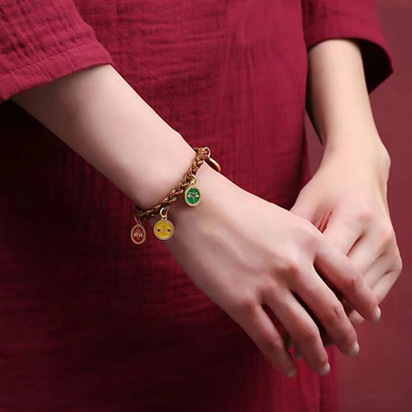 Woman wearing Five God of Wealth Tibetan bracelet on left wrist with red traditional clothing
