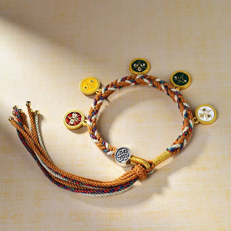 Tibetan five gods of wealth luck bracelet flat lay displaying round enamel charms and gold-toned fasteners