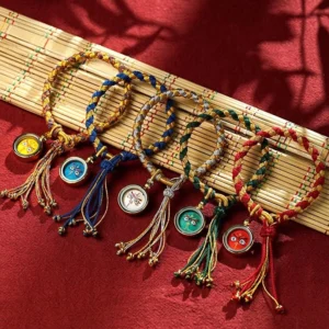 Collection of colorful Tibetan Five Gods of Wealth bracelets showing multiple color variants with different deity charms on red velvet background