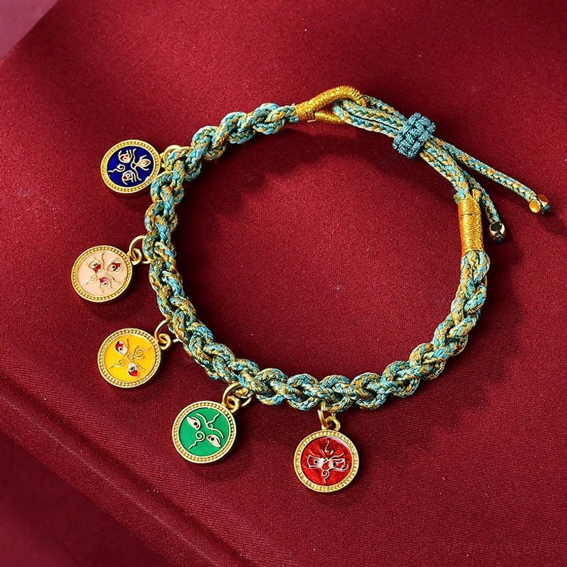 Cyan and gold braided Tibetan wealth bracelet with five religious enamel pendants on red velvet background