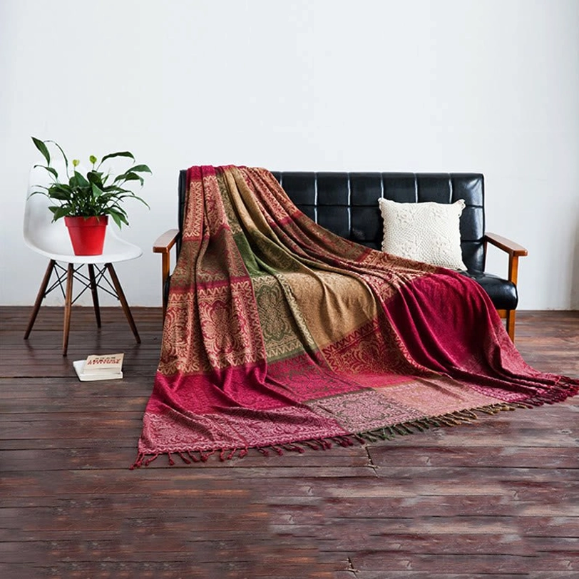 Full Tibetan floral chenille throw blanket draped across living room sofa, demonstrating generous size and complete coverage with warm coordinated colors