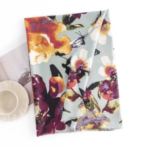 Mint green Tibetan floral butterfly scarf flat lay on minimalist tableware background