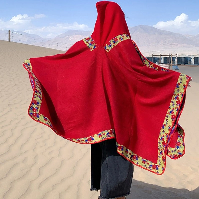 Tibetan floral poncho detail photography highlighting handcrafted border and authentic Himalayan motifs