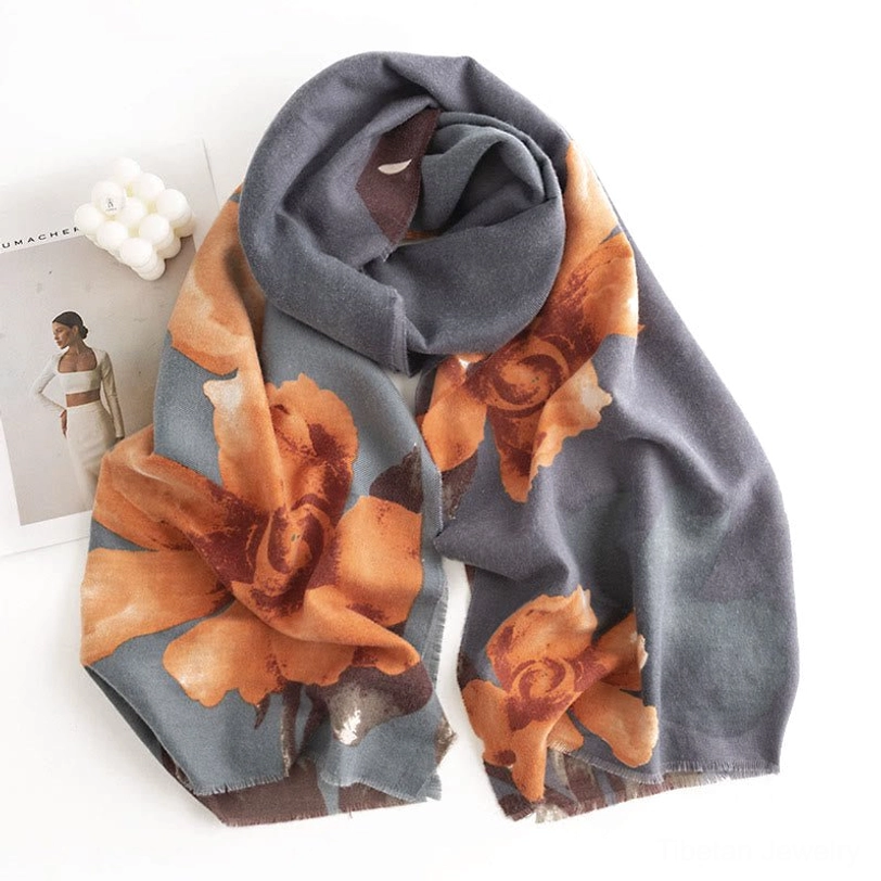 Tibetan hibiscus scarf draped elegantly with large orange floral prints on dark gray base