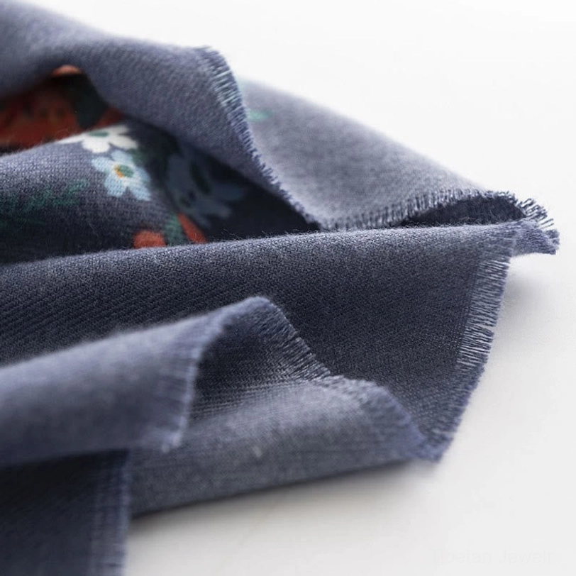 Tibetan floral wrap scarf in steel blue colorway styled as versatile shoulder wrap and evening shawl