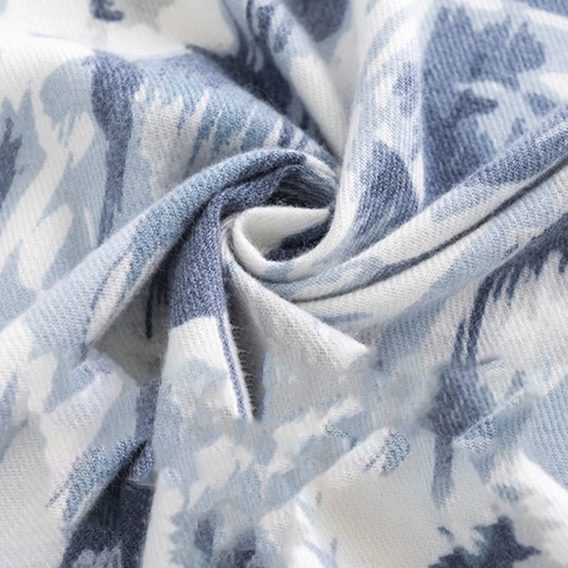 Twisted close-up view of Tibetan floral print scarf highlighting draped fabric details in blue, light blue and white tones with soft wrinkled texture