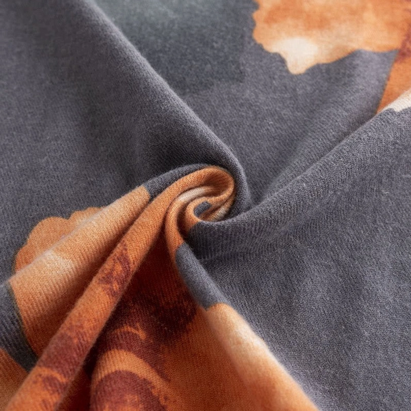 Twisted overhead close-up of Tibetan floral scarf revealing subtle hibiscus prints and soft drape