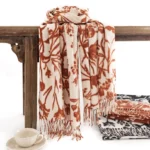 Tibetan floral tassel shawl in cream and rust red, hanging display showing soft drape and fringe detail