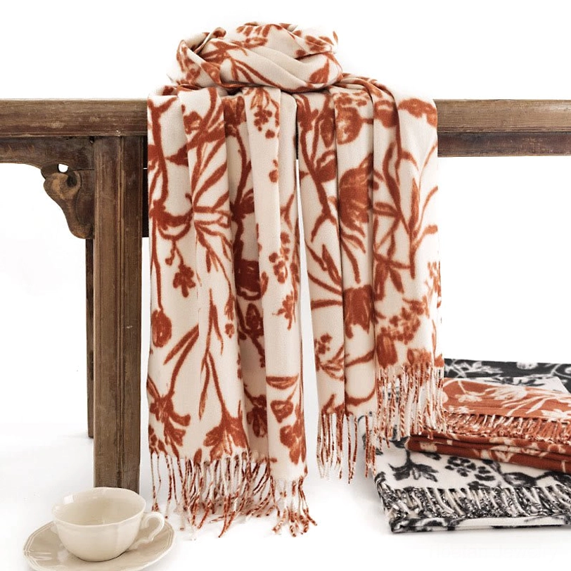 Tibetan floral tassel shawl in cream and rust red, hanging display showing soft drape and fringe detail