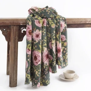 Tibetan floral shawl with pink blooming flowers and green leaves on dark green base - hanging display view