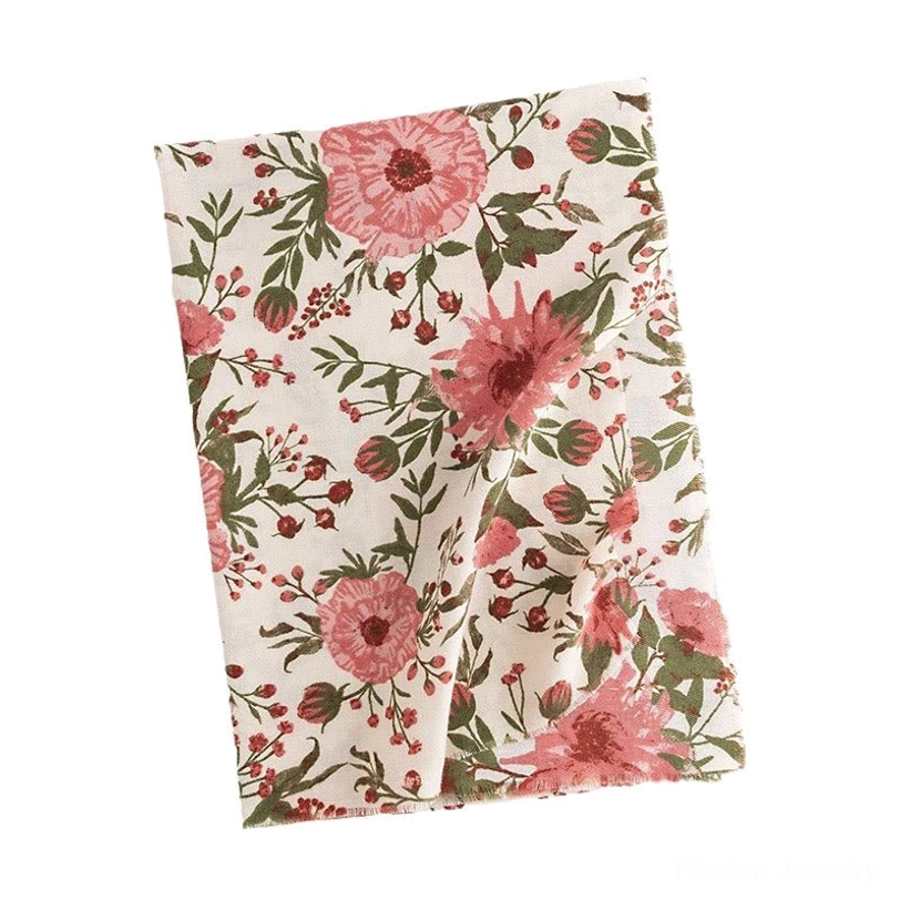 Full-length flat lay of Tibetan floral shawl on white background displaying complete botanical pattern and soft fabric placement