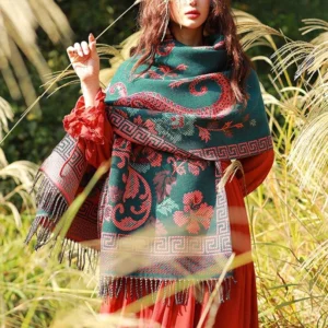 Tibetan floral paisley shawl wrap in dark green with red decorative patterns worn in outdoor reed field