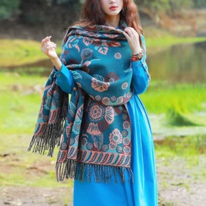 Tibetan floral cashmere shawl with botanical print worn as shoulder wrap by lakeside