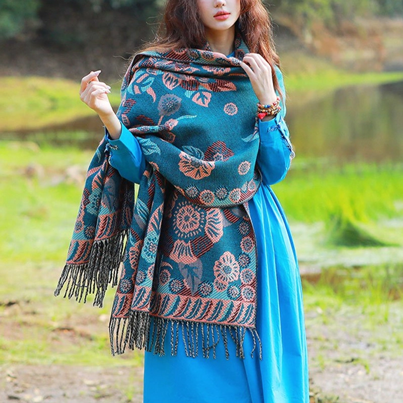 Tibetan floral cashmere shawl with botanical print worn as shoulder wrap by lakeside