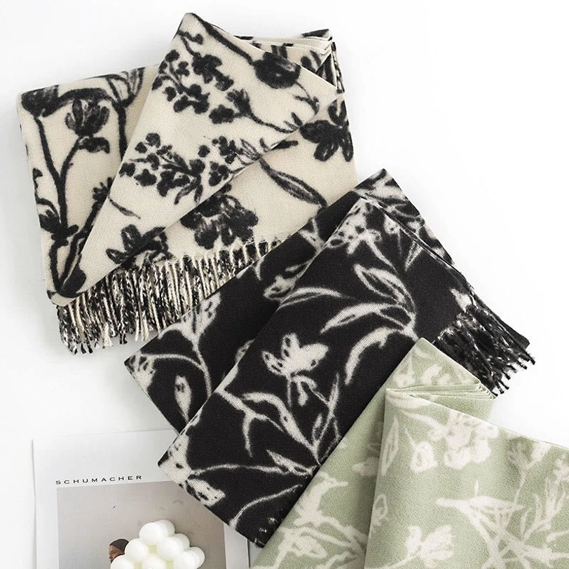 Assorted Tibetan floral shawls collection showing multiple color and print options in flat lay arrangement