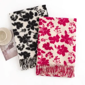 Flat lay comparison of two tibetan flower print shawls - black and rose red styles with matching tassel trims