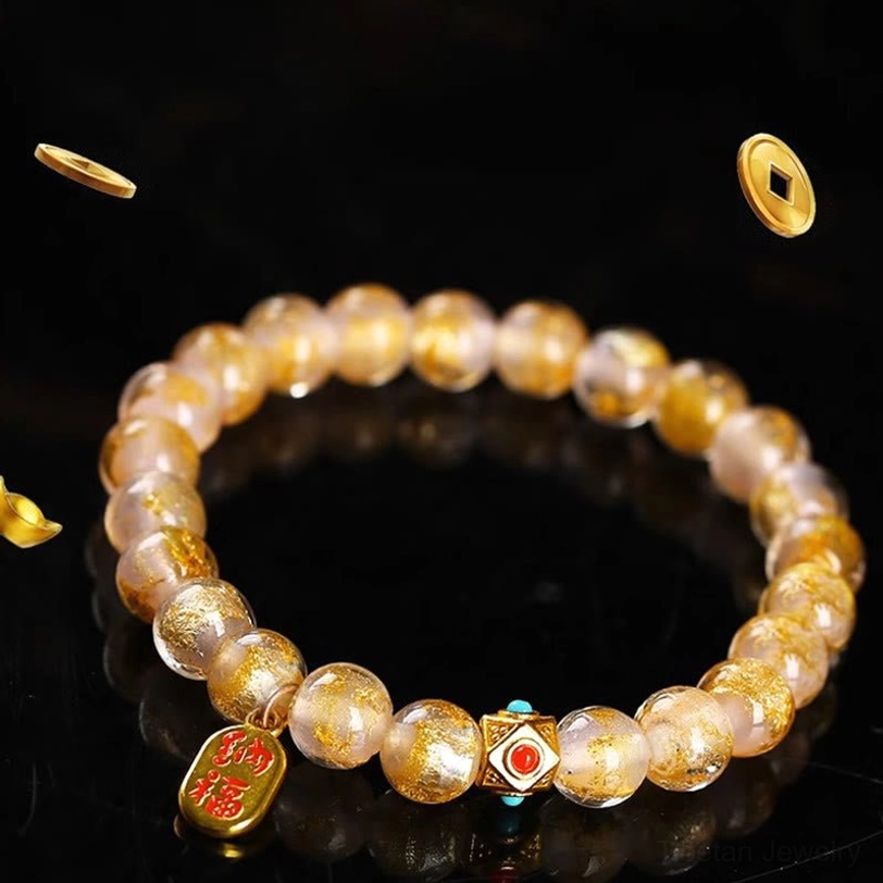 Translucent gold glass beads fu character charm bracelet with enamel spacer on black background with gold decorations