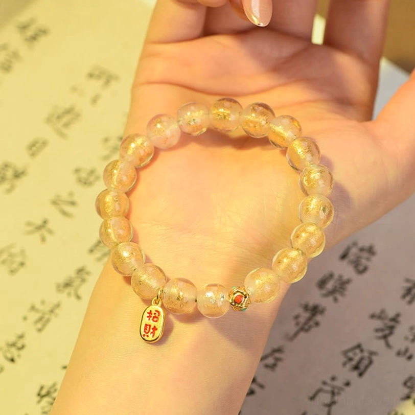 Wrist wear view of tibetan incense ash liuli glass bracelet with fu character charm on calligraphy background
