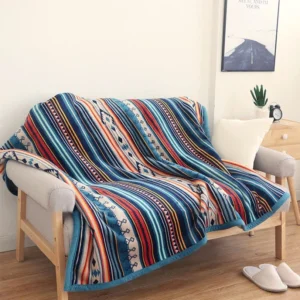 Tibetan geometric throw blanket with bohemian tribal print draped on living room sofa, featuring blue binding edge and multi-color ethnic pattern